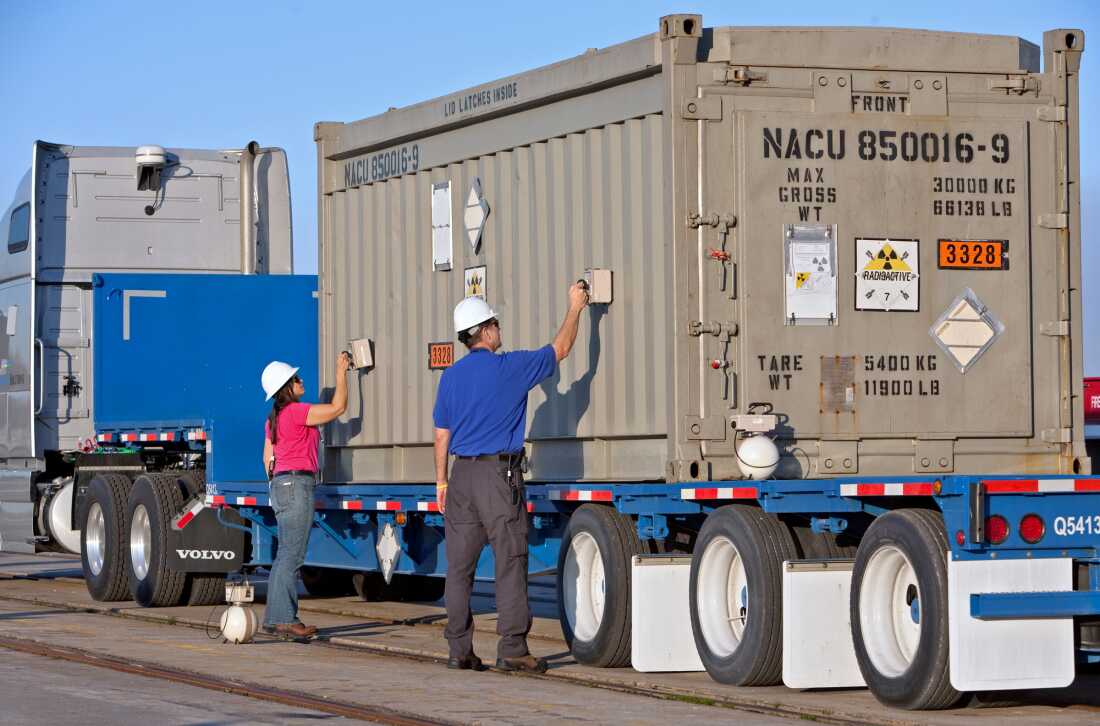 Two employees from the National Nuclear Security Administration use gamma detectors to test the outside of a container of highly-enriched uranium for surface contamination at the Charleston Weapons Station near Goose Creek, S.C. on March 19, 2010.